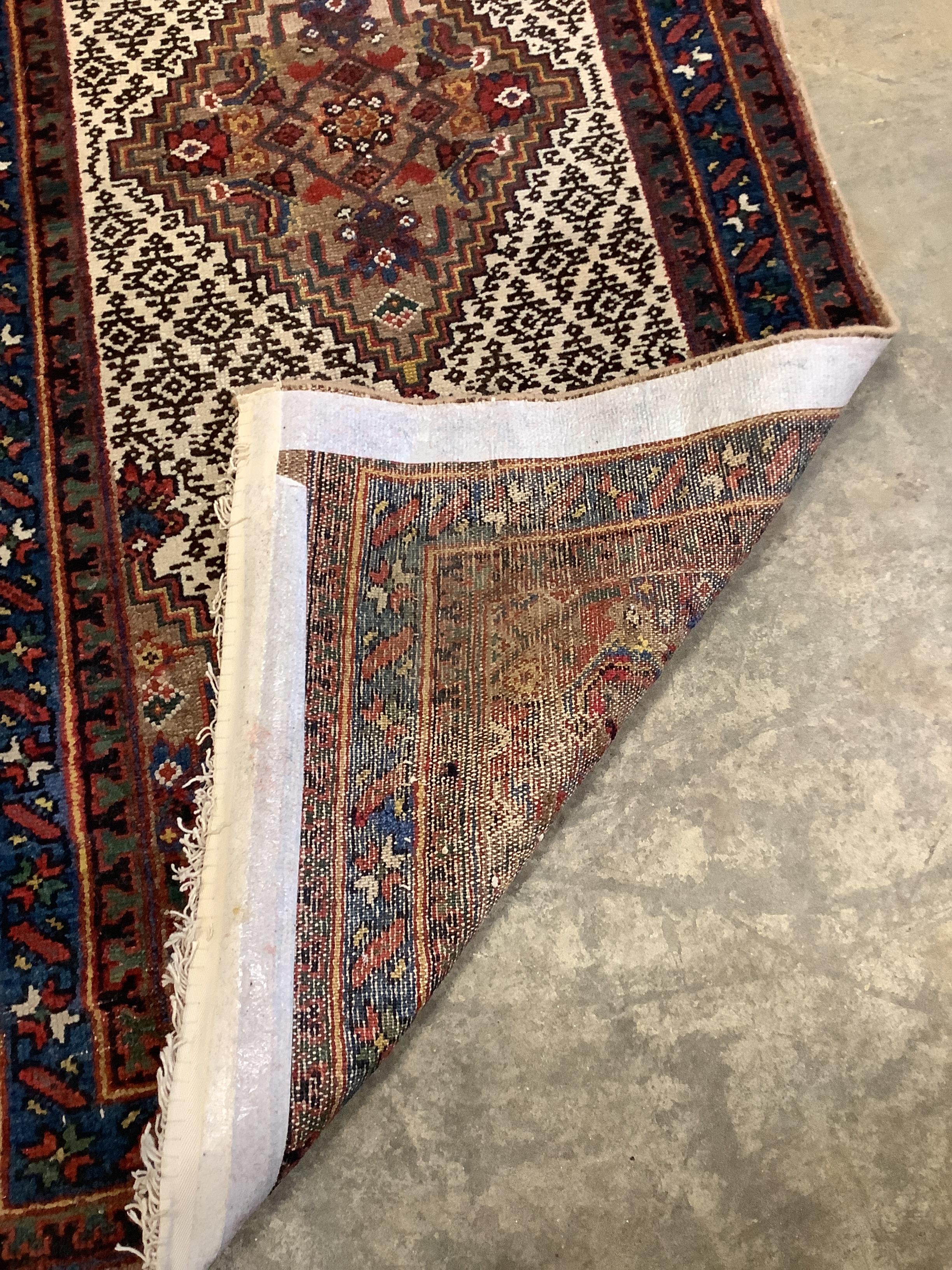 A Kurdish village red ground runner, 540 x 78cm